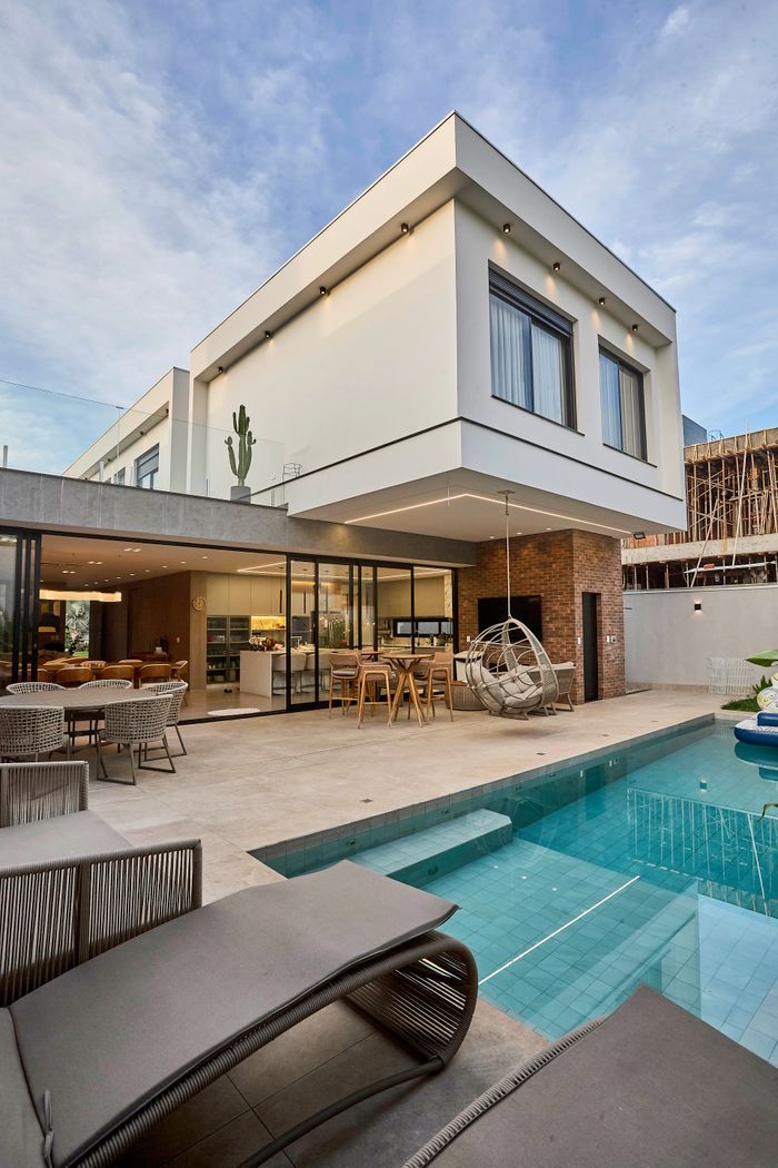 gallery-5 Explore this stunning modern home featuring an elegant poolside area.