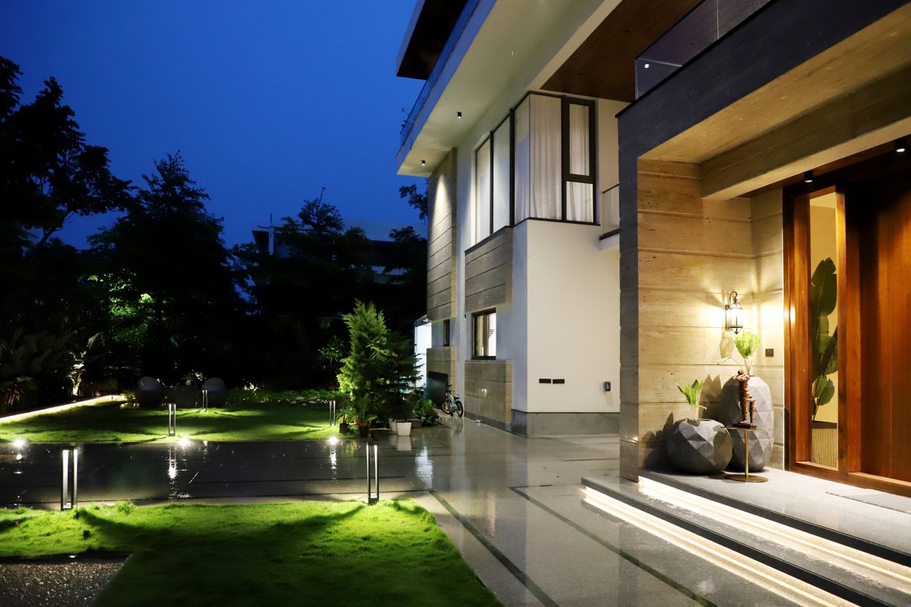 gallery-3 Elegant residential architecture illuminated at night, showcasing modern design and lush garden.